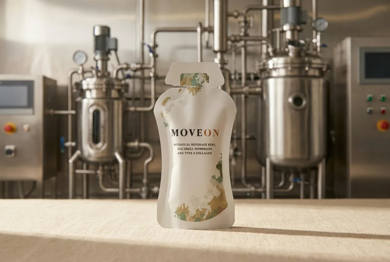 A MoveOn sachet torn open, with the advanced extraction and manufacturing line that makes a stable ready-to-drink liquid behind it